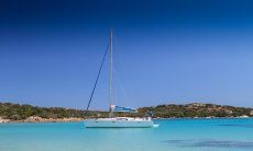 Sailing boat floating on the crystal clear water of Cala di Volpe