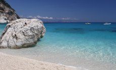Big, white round rock in the crystal clear water in front of the beach of Cala Goloritze