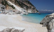 White, limestone beach of Cala Goloritze with view on the sea and the steep cliffs of the coast