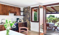 Apartment Castededdu 10 | Living area with kitchen, dining table and garden access Living area with kitchen, dining table and garden access