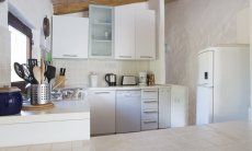 Open space kitche with dishwaser, gas stove, fridge with freezer and electric devices