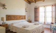 Villa Is Molas Monte | Bedroom 2 with double bed, big window and ensuite bath Bedroom 4 with double sized bed