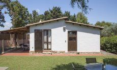 Casa Su Faru 5 | View of the garden, the house with roofed terraca and entrance doors to bedroom and livingroom View of the garden and house