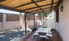 Casa Su Faru 5 | Roofed terrace with dining area outside Roofed terrace with dining area outside