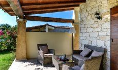 Outside couch on the roofed terrace of  Villa Campidano 21