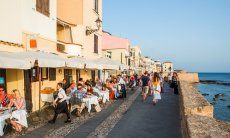 Romantic boardwalk of Alghero with restaurants with sea view