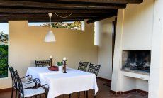 Terrace with dining table and outdoor chimney 