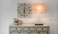Chest of drawers shabby with clock and lamp