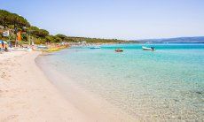 White sand and crystal clear water of the beach Le Bombarde Alghero