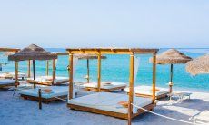 Luxurious sunbeds and parasols on the beach Maria Pia close to Alghero