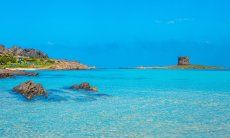 View over the crystal clear sea onto the beach of La Pelosa, Stintino