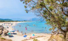 Just a few ombrellas and people even in high season on the beach of Feraxi, Capo Ferrato