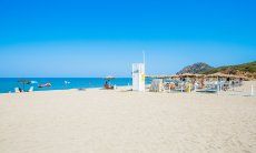 Large, white sandy beach Feraxi and ombrellas from the lido Il Delfino