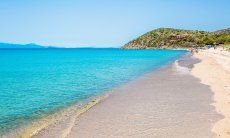 Beach of Geremeas with crystal clear water and Torre delle Stelle in the background