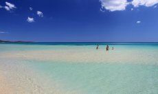 People bathing in the crystal clear sea of Cala Sinzias