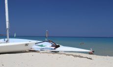 Surf an Laser on the beach of Cala Sinzias