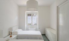 Villa Pola | Bedroom 3 with two single beds and window onto the garden Bedroom 3 with two single beds and window onto the garden