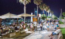 Alghero at night: the boardwalk along the harbour is well illuminated and animated by visitors