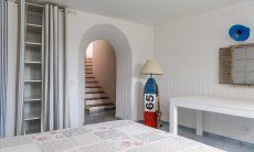 Li Conchi 30 | Stairs leading to bedroom 3 in the basement with double bed and wall closet Presentation of Li Conchi 30