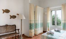 Li Conchi 30 | Baedroom 1 with double bed, wall closet and wooden bench Presentation of Li Conchi 30