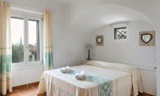 Li Conchi 30 | Bedroom 1 with double bed and window with garden view Presentation of Li Conchi 30
