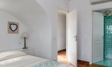 Li Conchi 30 | Bedroom 1 with the entrance door and door to the private bath Presentation of Li Conchi 30