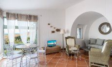 Li Conchi 30 | Relax area of the living room with round table in front of the panomrama window, TV and sofa corner Presentation of Li Conchi 30