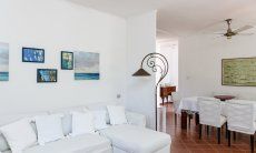 Casa Su Faru 2 | Livingroom with sofa and dining table Livingroom with sofa and dining table in Su Faru 2 Pula