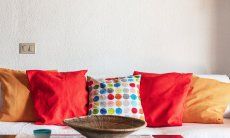 Apartment Nido 2 | Comfortabel couch with coloured cushions Nido 2, Costa Rei, South Sardinia