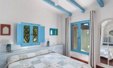 Casa 17 | Bedroom 1 with double bed and garden Casa 17, Sant Elmo, South Sardinia