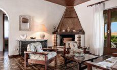 Villa Palme | Living room with big fire place and door to the terrace Living room with big fire place, Villa Palme, Costa Rei