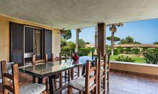 Villa Palme | Dining table on the roofed terrace Villa Palme, Costa Rei