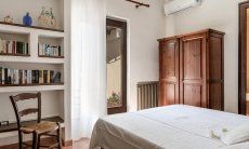 Villa Palme | Bedroom 1 with library and airconditioning Villa Palme, Costa Rei