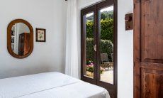 Villa Palme | Bedroom 3 with double bed and door to the terrace Bedroom Villa Palme, Costa Rei