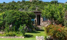 Villa Su Tauloni | Door from the green garden to one of the bedrooms Villa Su Tauloni, Is Molas, South Sardinia