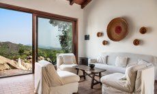Villa Fiorita | Comfotable seating area in the living room with view over the pool and valley Portrait of the villa