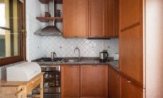 Villa Tiziana 11 | The kitchen boosts dishwasher, gas stove, electric oven and a big fridge and freezer Portrait of the house