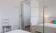 Villetta Fabio | Bedroom 1 with double bed and mirror cabinet Bedroom Villetta Fabio Costa Rei