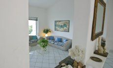 Villa Bella | Living room with terrace access Open arch between entrance and living room